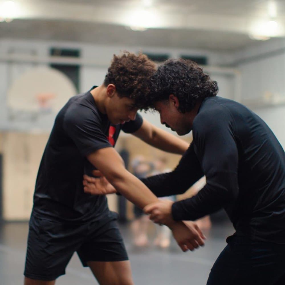 Teen students working a wrestling clinch