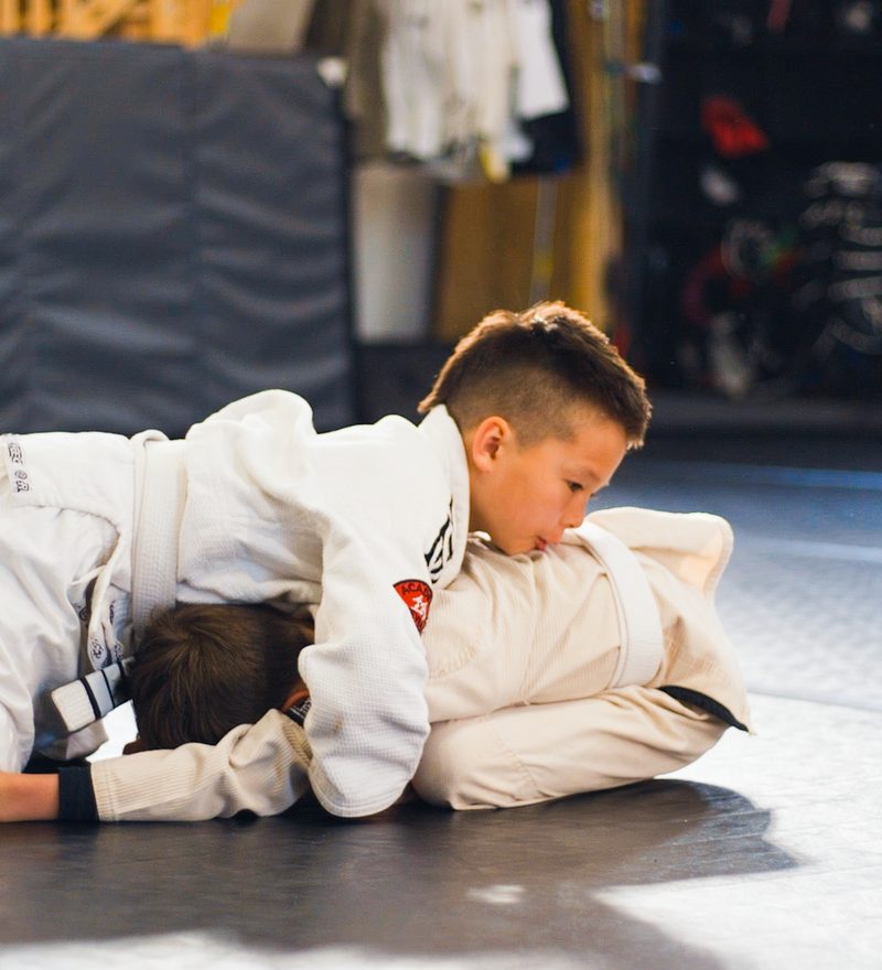 Kids practicing Brazilian Jiu-Jitsu ground positions
